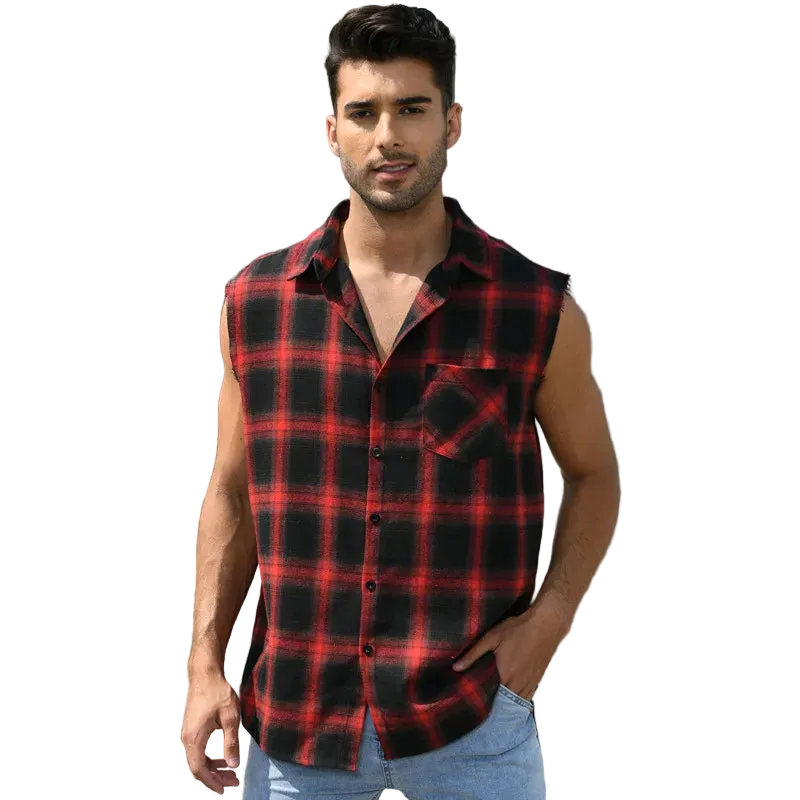Man wearing a red and black plaid sleeveless shirt standing in front of a building.