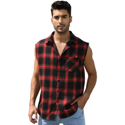 Man wearing a red and black plaid sleeveless shirt standing in front of a building.