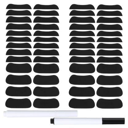 Two sheets of black curved eyelash adhesive patches shown on a white background, with two white-and-black markers placed below the sheets.