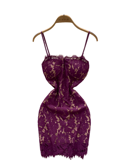 Purple lace dress on a hanger with decorative background