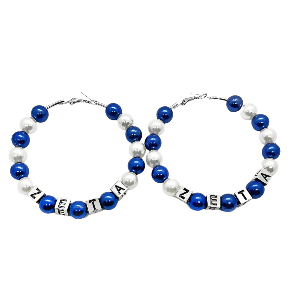 Pair of hoop earrings with blue and white beads and 'ZETA' letter beads on a white background