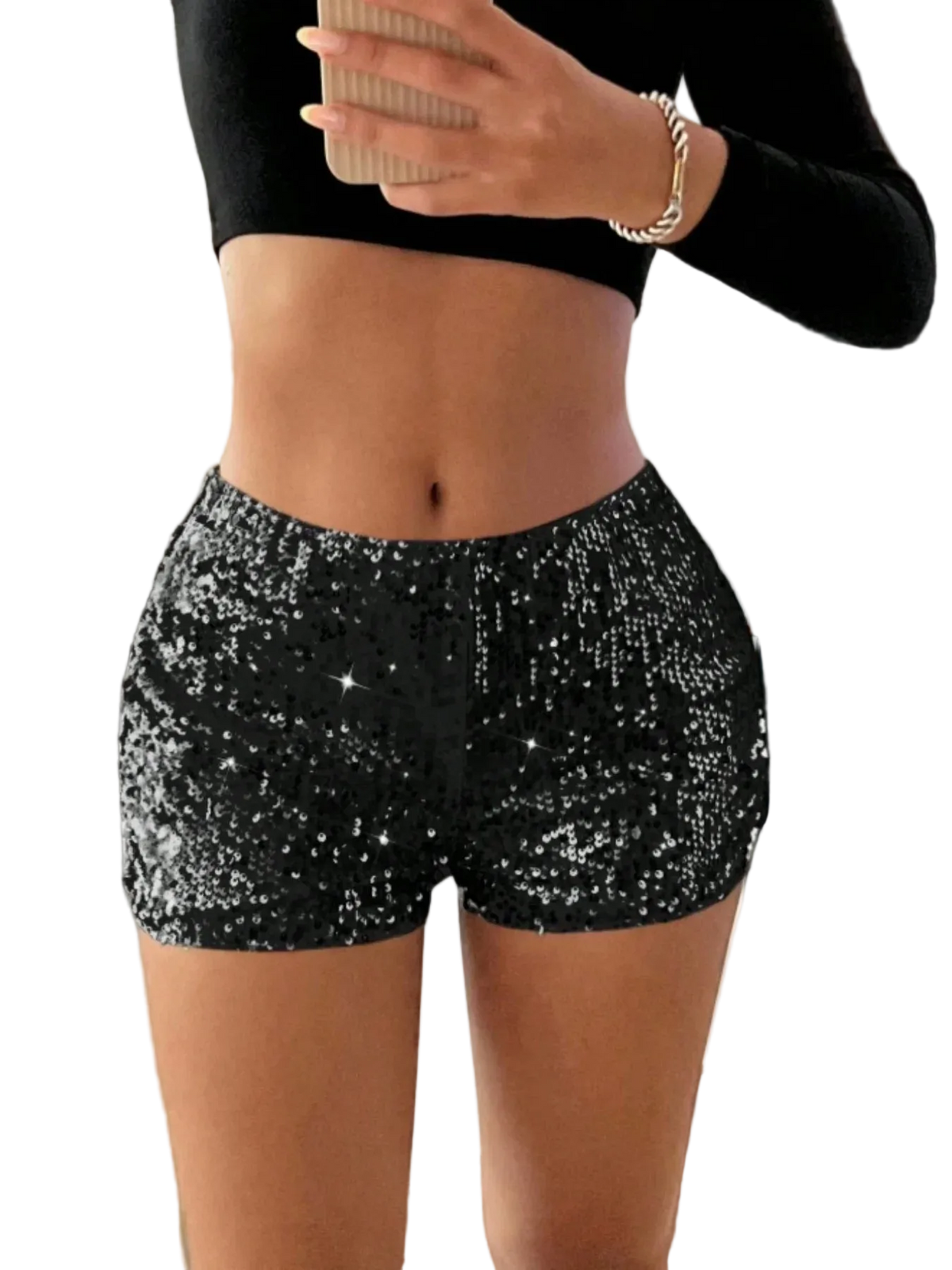 Person wearing black sequin shorts and a black top, holding a cup indoors.