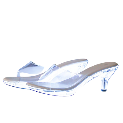Clear high-heeled shoes with heel and platform measurements on a reflective surface.