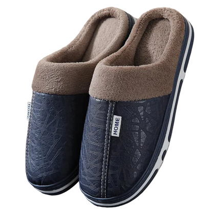 Pair of blue slippers with brown fuzzy lining on a neutral background
