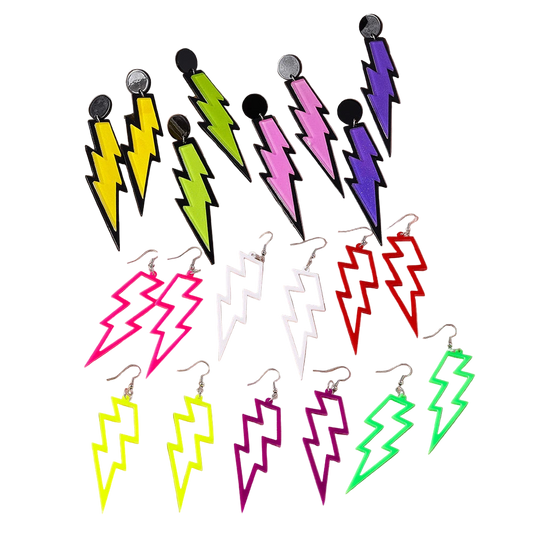 Colorful lightning bolt earrings on a pink satin background