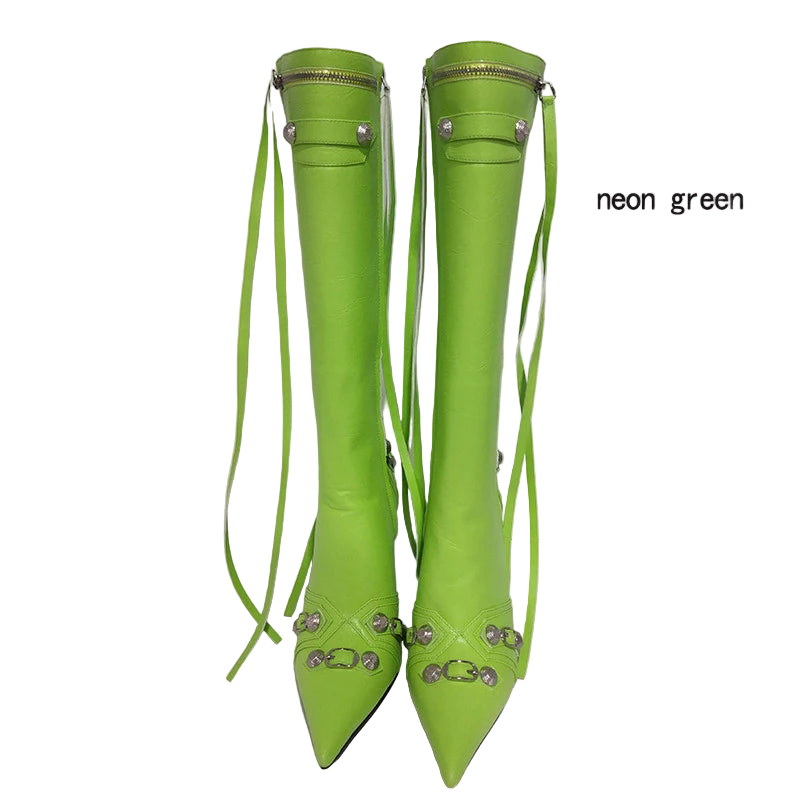 Neon green knee-high boots with decorative straps on a white background