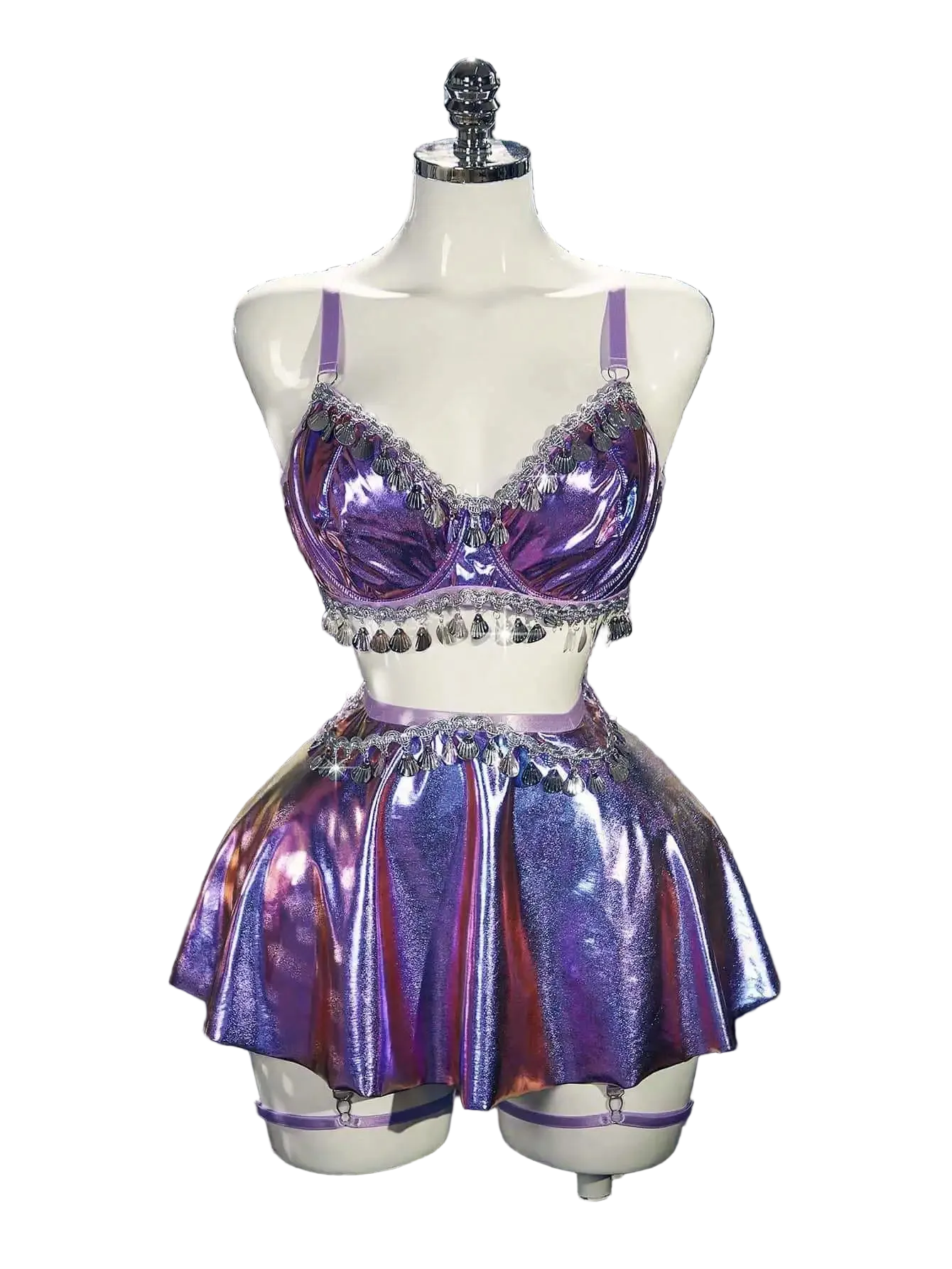 Purple sequin two-piece outfit on a mannequin against a silver tinsel background.