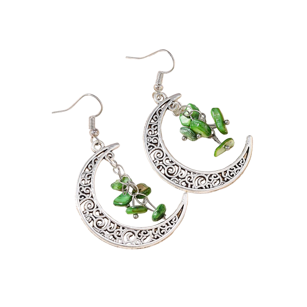 Silver earrings with green beads on a textured stone surface