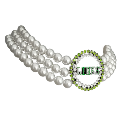 Pearl necklace and green and silver 'LINKS' bracelet on a black stand