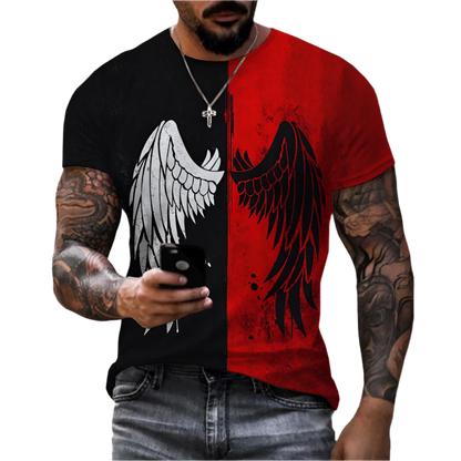 T-shirt with a bold design split into two halves. The left side is black with a white angel wing, and the right side is red with a black angel wing. The shirt is worn by a person with tattooed arms, holding a phone, and wearing a cross necklace.