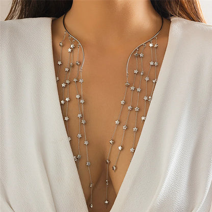 Star-shaped body chain worn by a model in a white outfit