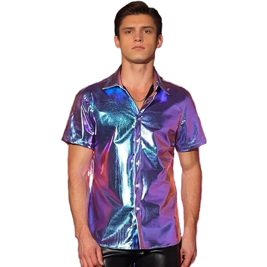A man wearing a short-sleeve iridescent button-up shirt with a metallic purple, blue, and pink sheen, standing in front of a shiny tinsel curtain backdrop.