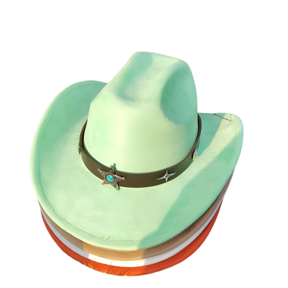 Green cowboy hat with a star and turquoise stone on a grassy background
