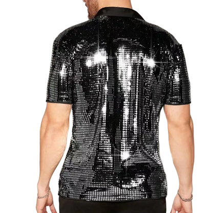 Person wearing a black sequin shirt on a plain background