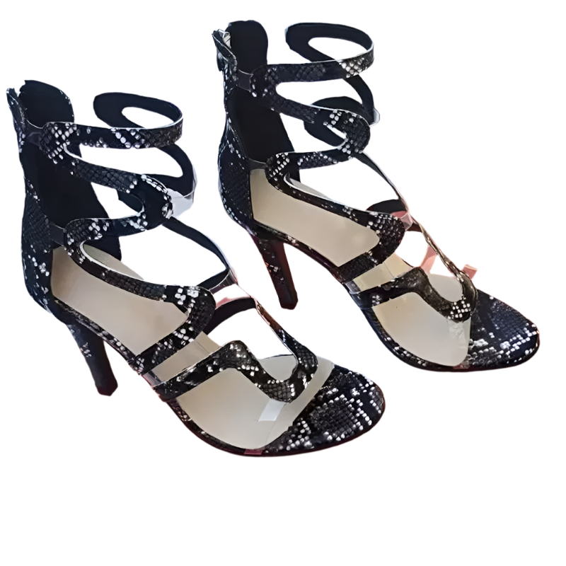 Black strappy high-heeled shoes on an orange 'fashion & shoes' box.