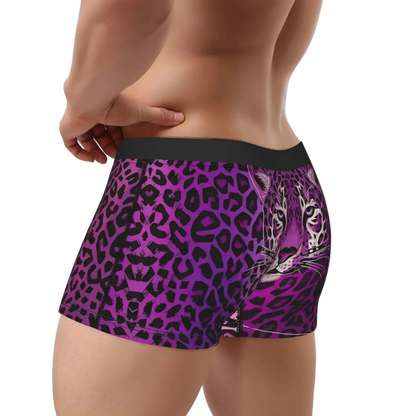A close-up of a male model's lower back and hips wearing boxer briefs with a purple and black leopard print and a graphic of a tiger's face on the right side.