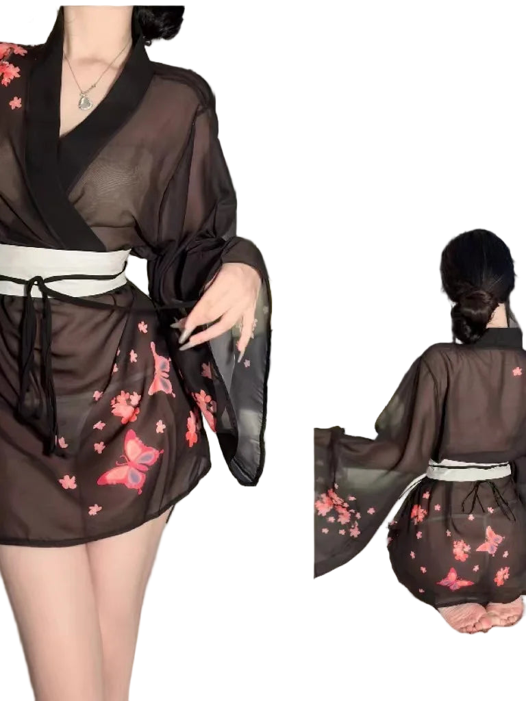 Person wearing a black kimono-style outfit with floral patterns, standing in a neutral setting.