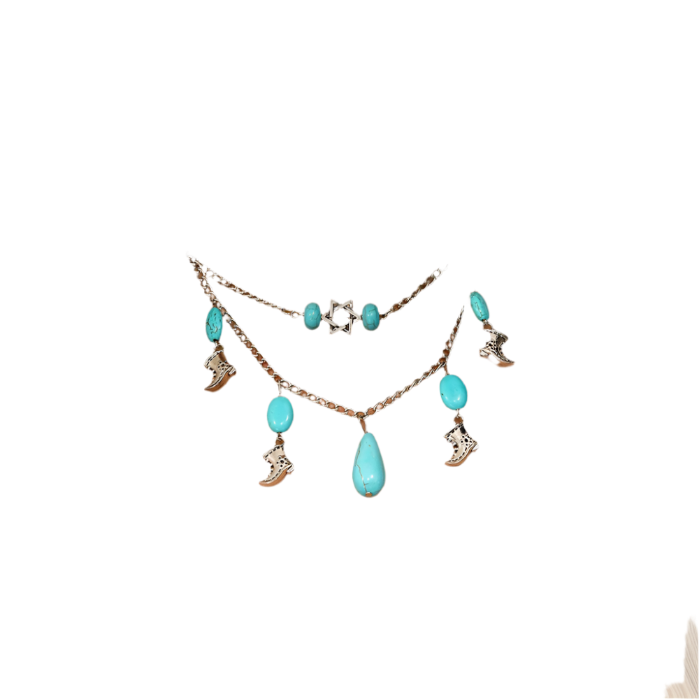 Necklace with turquoise stones and charms on a person wearing a white top