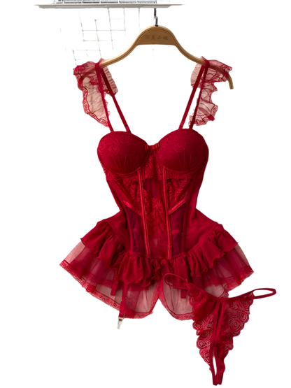 Red lace lingerie set on a hanger with flowers and a rug in the background