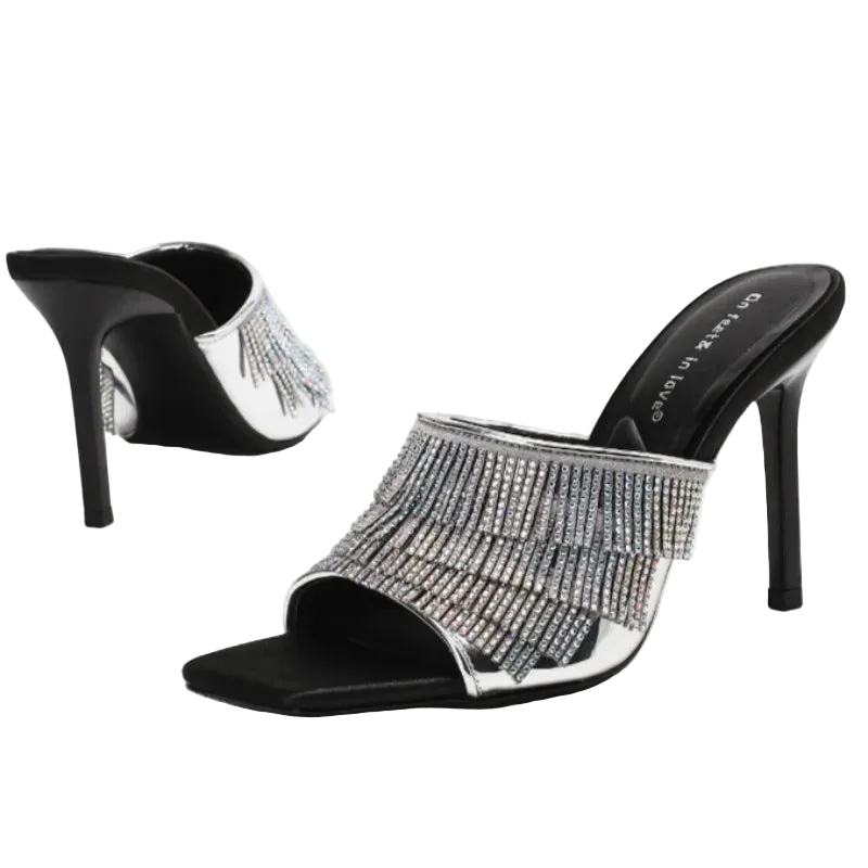 A pair of black and silver high-heeled mule sandals with a fringe of sparkling rhinestones across the open toe, shown on a clean white background.