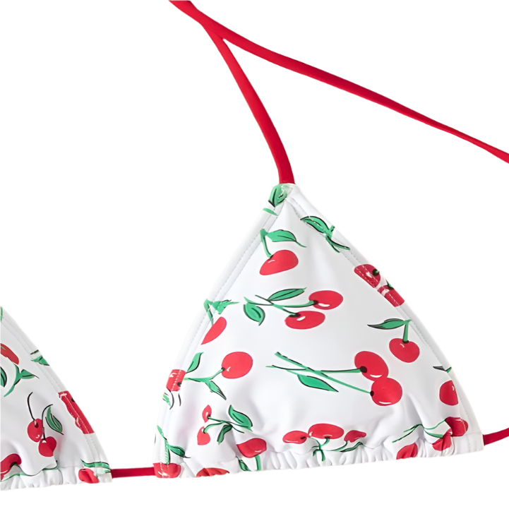 A white bikini with a cherry print. It features a classic triangle top and tie-side bottoms with red strings, giving it a playful and fruity look.
