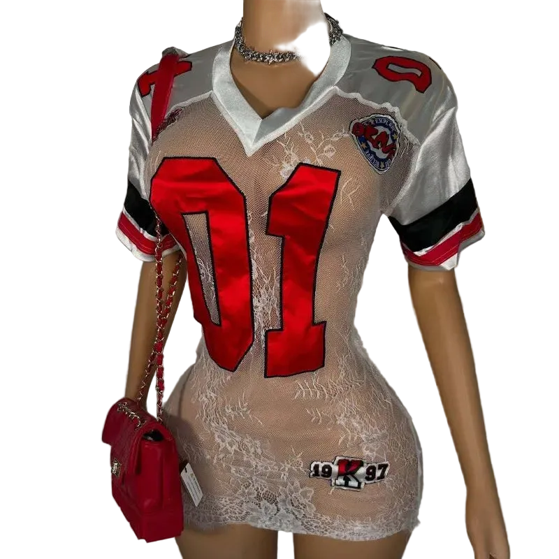 Mannequin wearing a sheer dress with red numbers and a red purse, against a plain background.