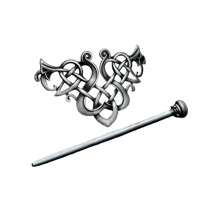 Silver hairpin with intricate design on a dark textured surface