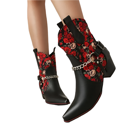 Black ankle boots with red floral and chain design on a neutral background