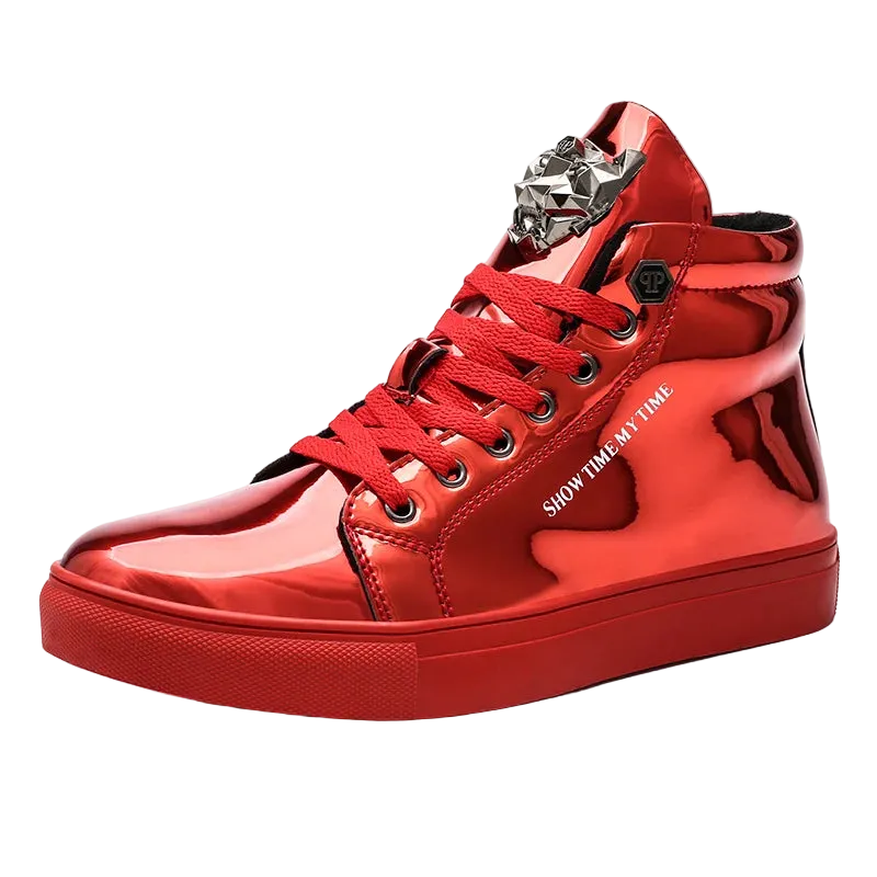 A glossy red high-top sneaker with red laces, a chunky red sole, and a silver metallic decorative ornament on the tongue, shown against a plain white background.