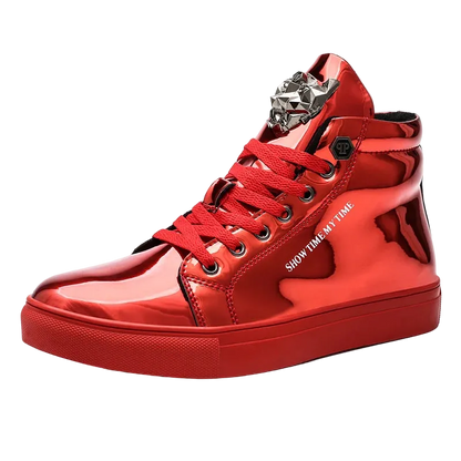 A glossy red high-top sneaker with red laces, a chunky red sole, and a silver metallic decorative ornament on the tongue, shown against a plain white background.