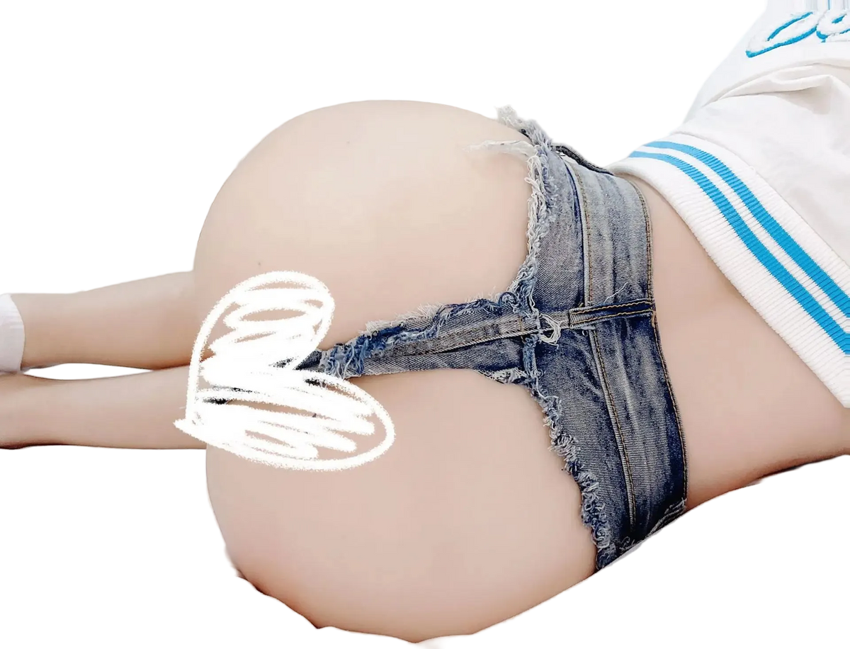 A close-up lifestyle shot of a person lying on a white bed, wearing frayed denim thong underwear and a white cropped sweatshirt with blue stripes. The image has a white scribble overlay obscuring the censored area.