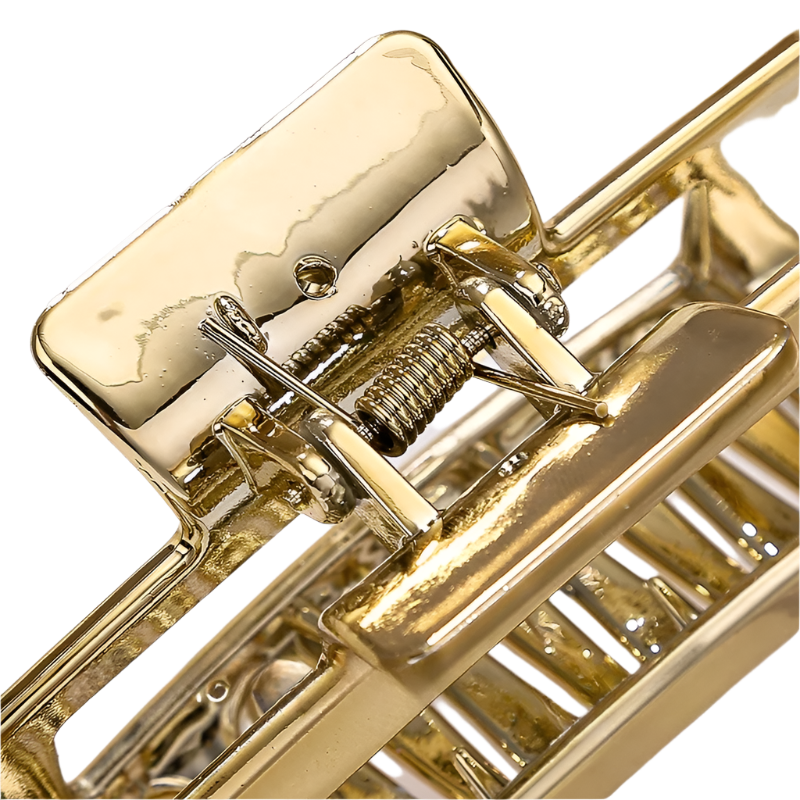 Close-up of a gold mousetrap on a light background