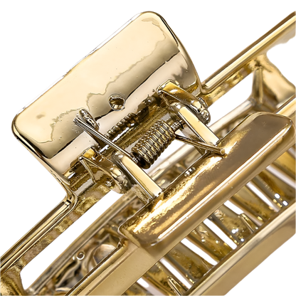 Close-up of a gold mousetrap on a light background