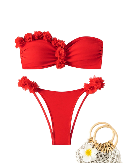 Red bikini set with floral details on a light gray background