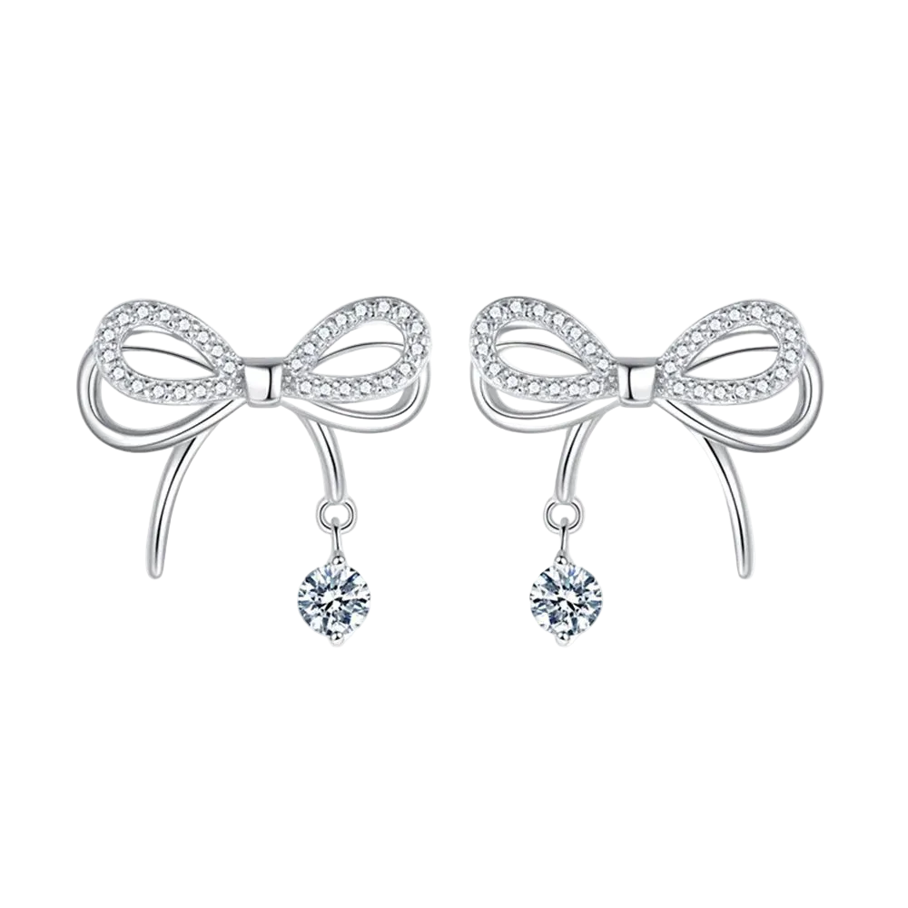 Bow-shaped earrings with dangling crystals on a white background
