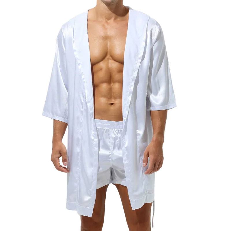 Man wearing a white satin robe and shorts on a white background