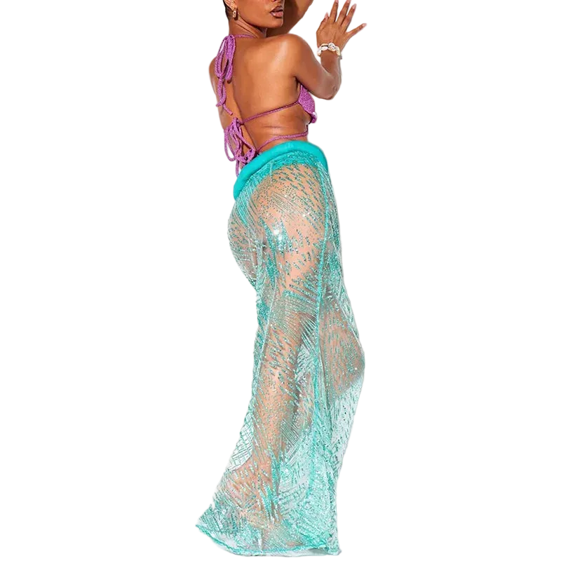 Woman wearing a purple bikini top and teal lace cover-up on a white background