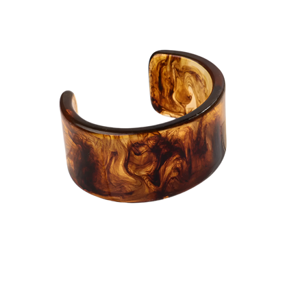 Bold leopard print wide cuff bangle featuring hollow geometric patterns and premium resin design for resort wear and theme nights

