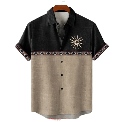 Black and beige shirt with sun design on a hanger against a white background