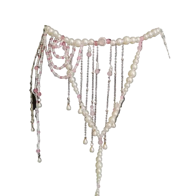 Pearl and chain belt on a black dress form against a white background