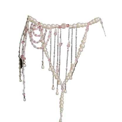 Pearl and chain belt on a black dress form against a white background