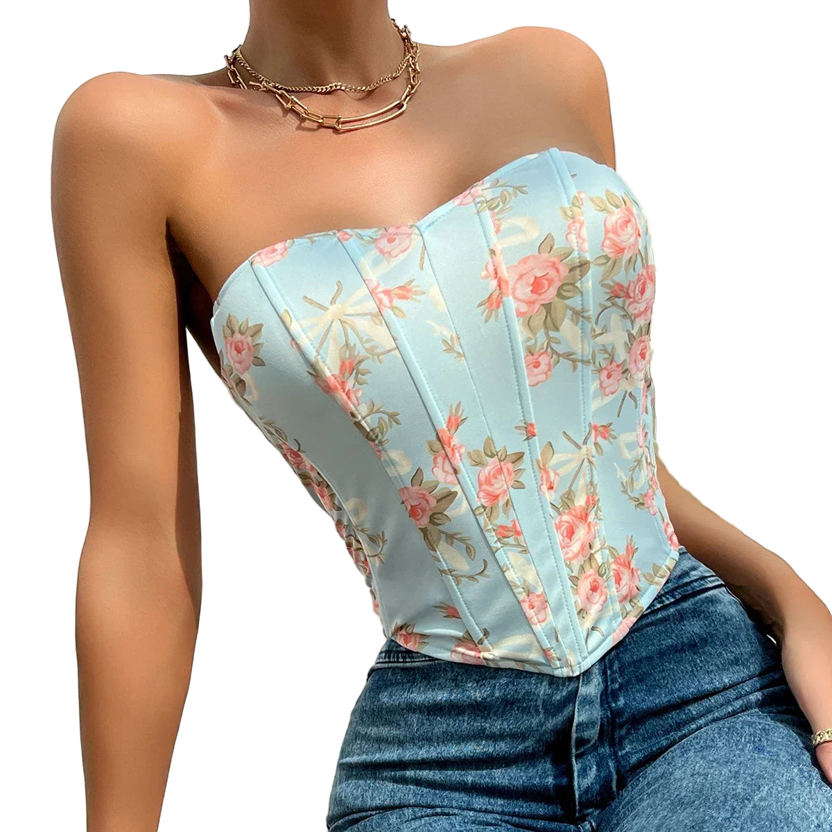 Woman wearing a floral strapless top and jeans with a white background