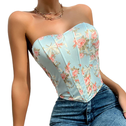 Woman wearing a floral strapless top and jeans with a white background