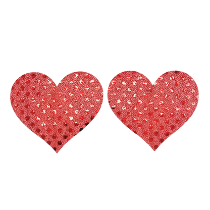 Red glittery heart-shaped pasties on a white background