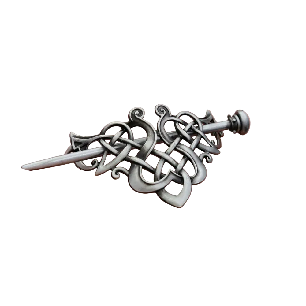 Decorative silver sword pendant held in a hand against a dark background