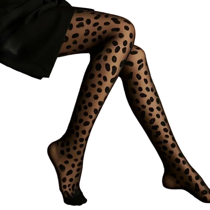 Black leopard-print tights worn by a model sitting on a gold-colored leather bench.