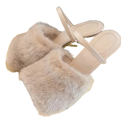 Beige sandals with fluffy fur sole on a yellow surface