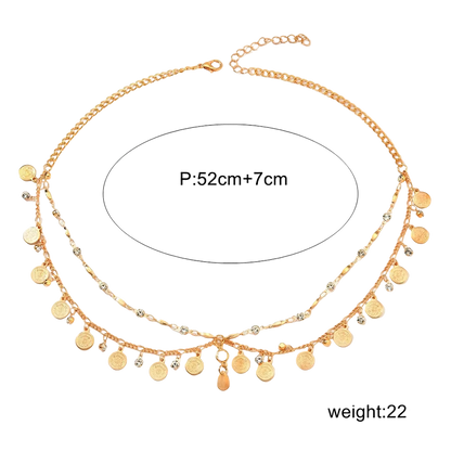 A gold-toned double-layered chain anklet with dangling coin charms and clear crystal accents, shown on a white background with a measurement circle reading 'P:52cm+7cm' and weight text 'weight:22g'.