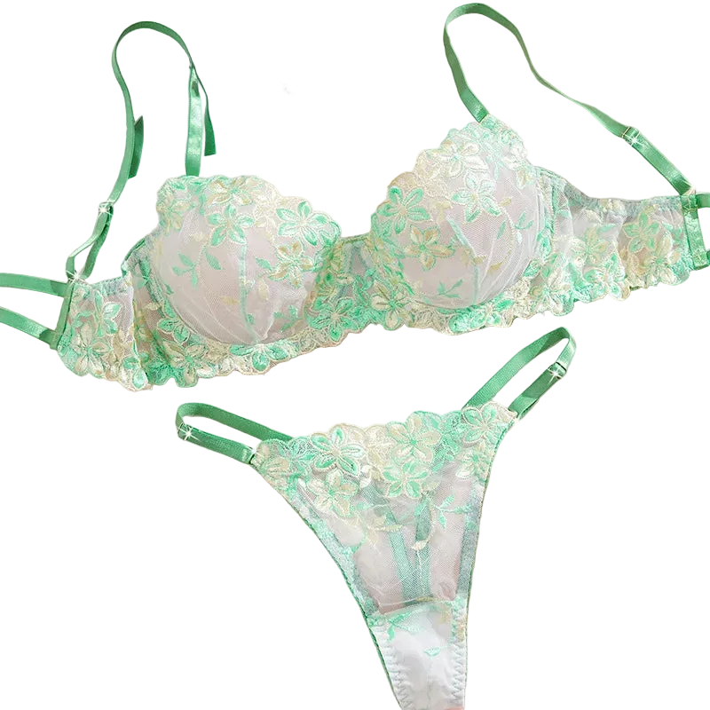 Green lace lingerie set on a soft pink background