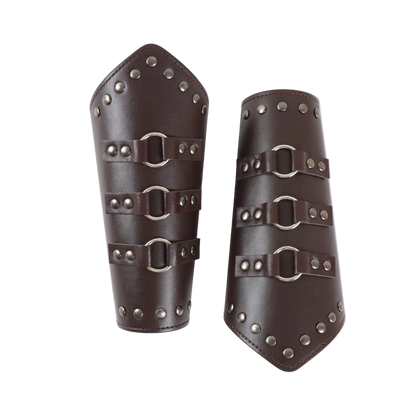 Pair of brown leather arm guards with metal buckles on a white background